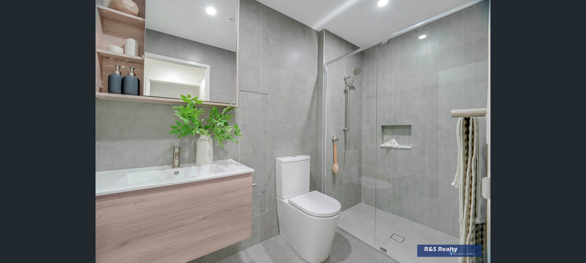 Bathroom with premium grey tiling and floating timber vanity