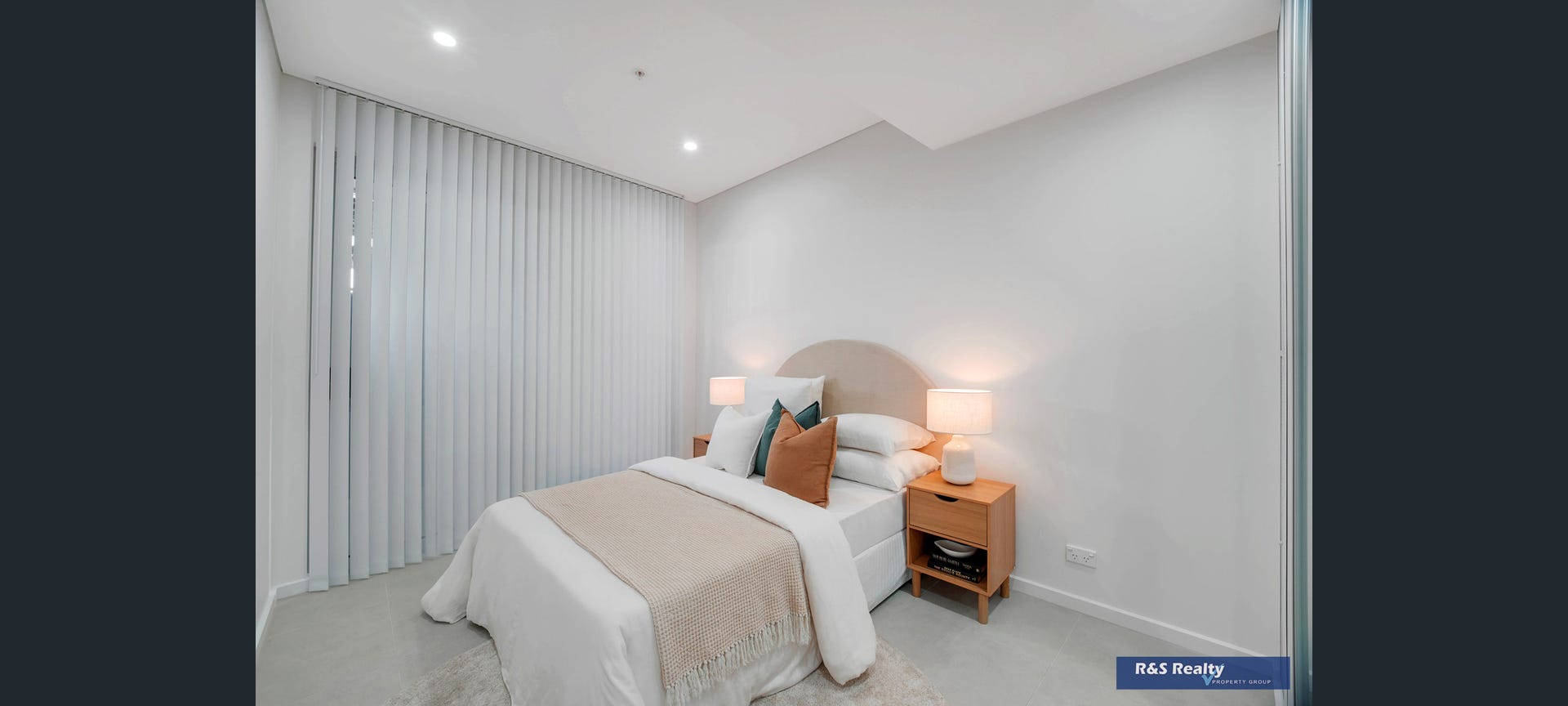 Second bedroom with warm timber bedside tables