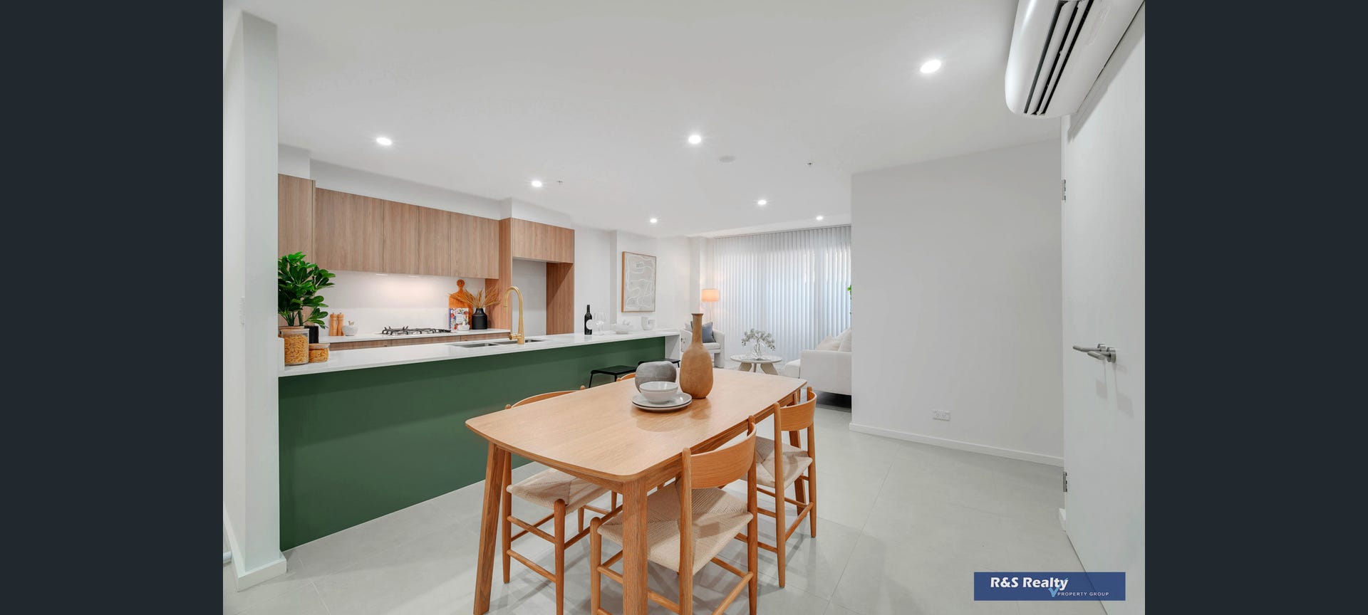 Designer kitchen with forest green island and brass tapware